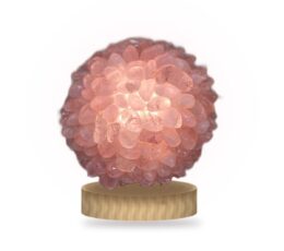 Lámpara de cuarzo rosa encendida, esfera de rodados con base de madera clara